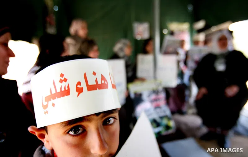 Palestinians hold portraits of jailed compatriots as they join a protest in solidarity with Hana Shalabi, a female Palestinian prisoner jailed in Israel who has been on hunger strike for 19 days, in the West Bank city of...