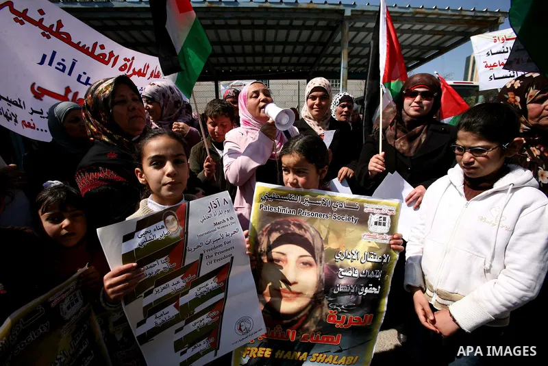 Palestinians hold portraits of jailed compatriots as they join a protest in solidarity with Hana Shalabi, a female Palestinian prisoner jailed in Israel who has been on hunger strike for 19 days, in the West Bank city of...