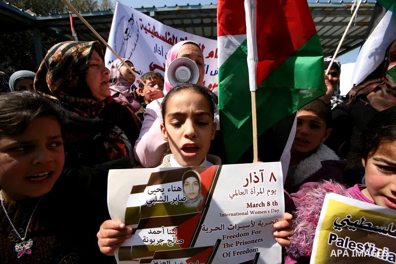 Palestinians hold portraits of jailed compatriots as they join a protest in solidarity with Hana Shalabi, a female Palestinian prisoner jailed in Israel who has been on hunger strike for 19 days, in the West Bank city of...