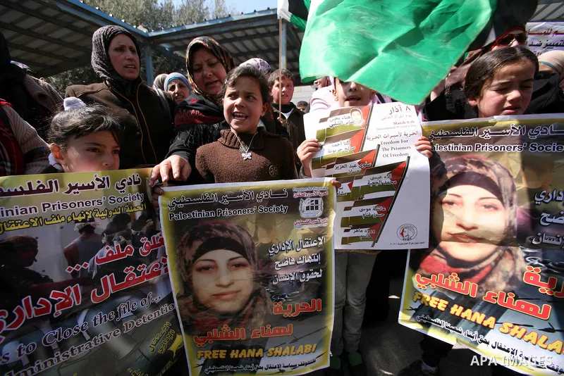 Palestinians hold portraits of jailed compatriots as they join a protest in solidarity with Hana Shalabi, a female Palestinian prisoner jailed in Israel who has been on hunger strike for 19 days, in the West Bank city of...