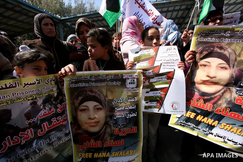 Palestinians hold portraits of jailed compatriots as they join a protest in solidarity with Hana Shalabi, a female Palestinian prisoner jailed in Israel who has been on hunger strike for 19 days, in the West Bank city of...