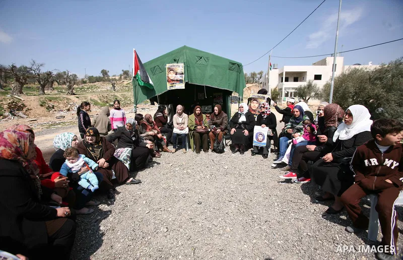 Palestinians hold portraits of jailed compatriots as they join a protest in solidarity with Hana Shalabi, a female Palestinian prisoner jailed in Israel who has been on hunger strike for 19 days, in the West Bank city of...
