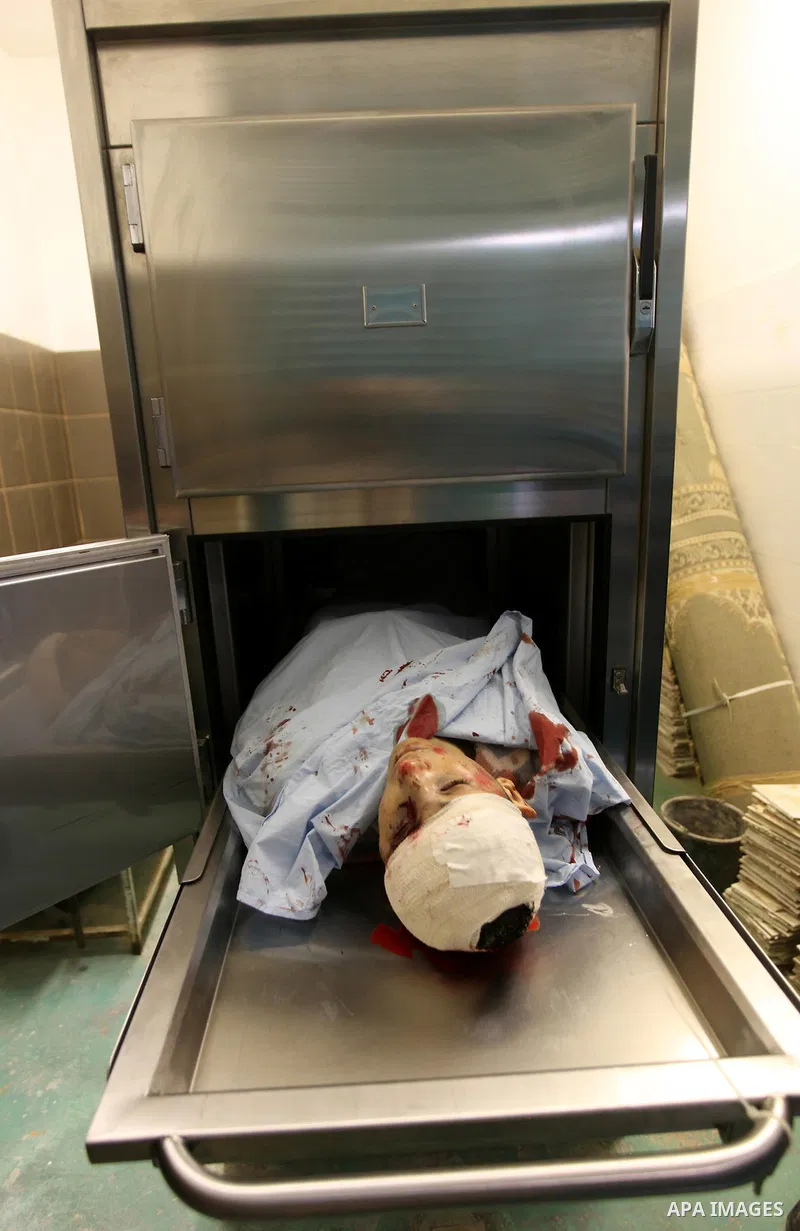 Relatives contemplate the dead body of Zakarya Abu Eram, who was shot dead by an Israeli soldier during an Israeli military operation in the village of Yatta, south of the West Bank town of Hebron, 08 March 2012. An Isra...