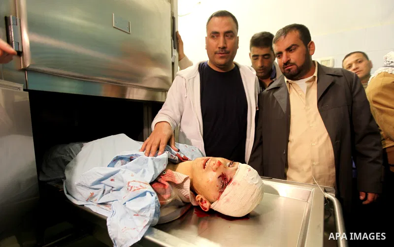 Relatives contemplate the dead body of Zakarya Abu Eram, who was shot dead by an Israeli soldier during an Israeli military operation in the village of Yatta, south of the West Bank town of Hebron, 08 March 2012. An Isra...