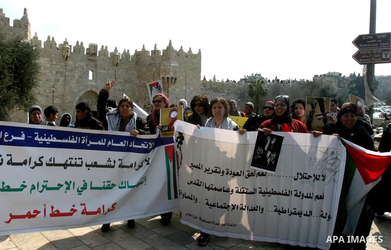 Women, holding Palestinian flags, shout slogans for the release of Hanaa al-Shalabi, a Palestinian woman freed in a prisoner swap with Israel but was re-arrested on February 16 2012, and has gone on hunger strike since,...