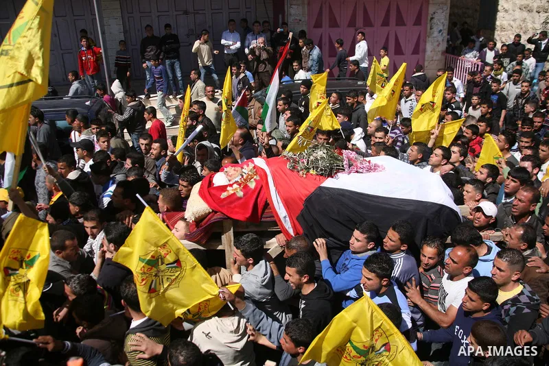 Palestinians carry the body of Zakariya Abu Eram during his funeral in the West Bank town of Yatta, near Hebron, Friday, March 9, 2012. According to the Israeli military, a Palestinian stabbed an Israeli soldier in the n...