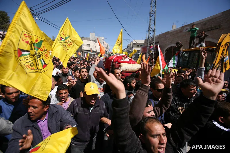Palestinians carry the body of Zakariya Abu Eram during his funeral in the West Bank town of Yatta, near Hebron, Friday, March 9, 2012. According to the Israeli military, a Palestinian stabbed an Israeli soldier in the n...