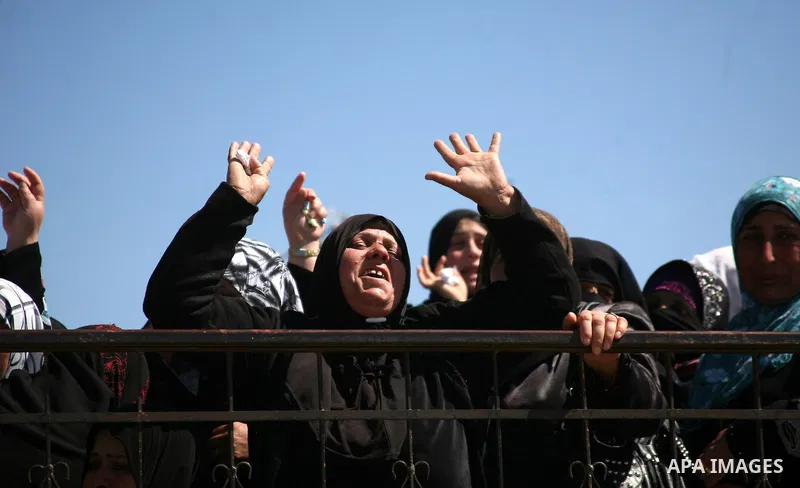 Palestinians women react during the funeral of Zakariya Abu Eram in the West Bank town of Yatta, near Hebron, Friday, March 9, 2012. According to the Israeli military, a Palestinian stabbed an Israeli soldier in the neck...