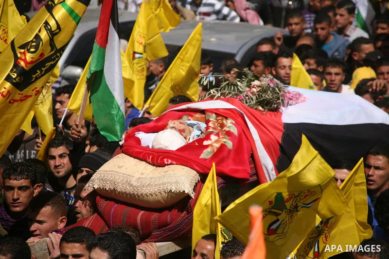 Palestinians carry the body of Zakariya Abu Eram during his funeral in the West Bank town of Yatta, near Hebron, Friday, March 9, 2012. According to the Israeli military, a Palestinian stabbed an Israeli soldier in the n...