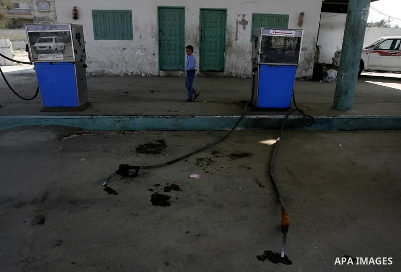 Palestinians wait to fill containers with fuel at a petrol station in Khan Younis in the southern Gaza Strip March 8, 2012. Palestinian Islamist group Hamas faces growing discontent in its Gaza stronghold because of rene...