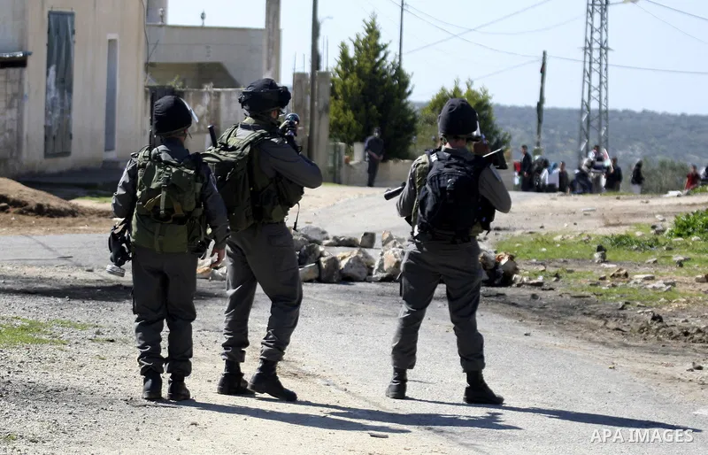 Israeli soldiers fire tear gas canisters at Palestinian protestors during a demonstration against the expropriation of Palestinian land by Israel in the village of Kafr Qaddum, near Nablus in the occupied West Bank on Ma...