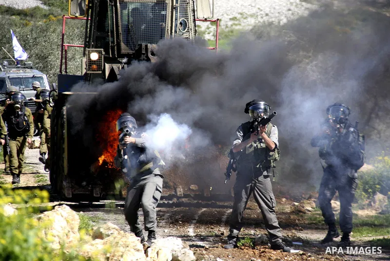 Israeli soldiers fire tear gas canisters at Palestinian protestors during a demonstration against the expropriation of Palestinian land by Israel in the village of Kafr Qaddum, near Nablus in the occupied West Bank on Ma...
