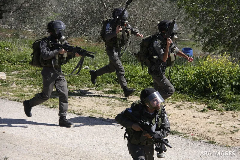 Israeli soldiers fire tear gas canisters at Palestinian protestors during a demonstration against the expropriation of Palestinian land by Israel in the village of Kafr Qaddum, near Nablus in the occupied West Bank on Ma...