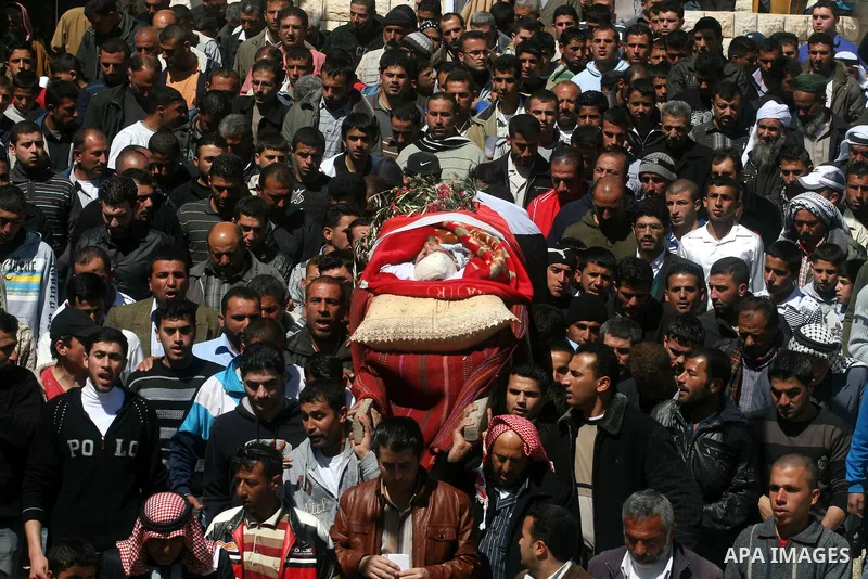 Palestinians carry the body of Zakariya Abu Eram during his funeral in the West Bank town of Yatta, near Hebron, Friday, March 9, 2012. According to the Israeli military, a Palestinian stabbed an Israeli soldier in the n...