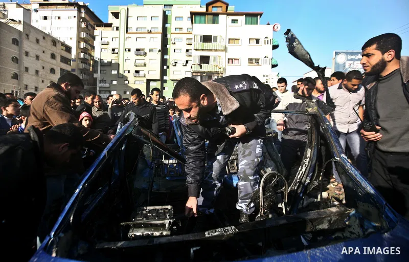 Palestinain policemen inspect the remains of a vehicle after it exploded in Gaza City March 9, 2012. Israel killed the leader of a Palestinian militant faction on Friday in a targeted attack on the car in the Gaza Strip,...