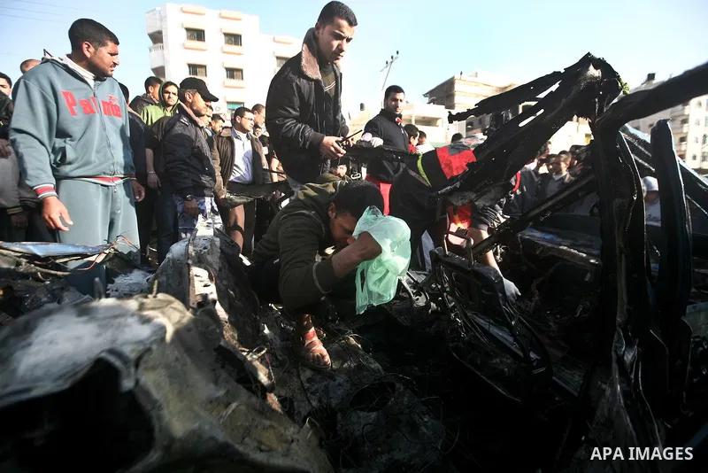 Palestinain policemen inspect the remains of a vehicle after it exploded in Gaza City March 9, 2012. Israel killed the leader of a Palestinian militant faction on Friday in a targeted attack on the car in the Gaza Strip,...