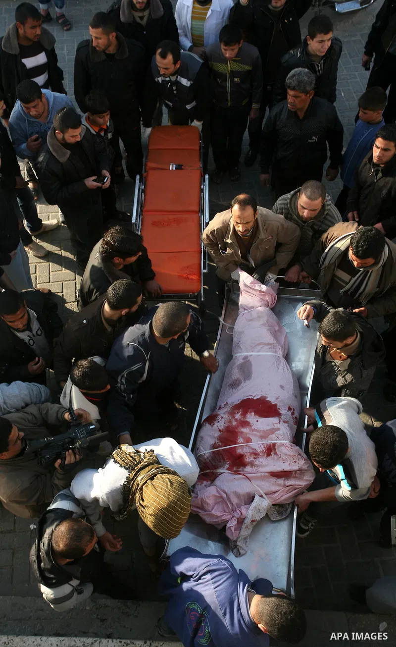 Palestinian carry the body of Zuhair al-Qaissi, a commanderl of the armed wing of the Popular Resistance Committees (PRC) in Gaza City, Friday, March 9, 2012. An Israeli airstrike killed top Palestinian militant commande...