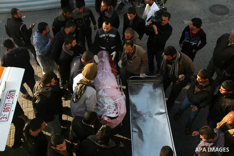 Palestinian carry the body of Zuhair al-Qaissi, a commanderl of the armed wing of the Popular Resistance Committees (PRC) in Gaza City, Friday, March 9, 2012. An Israeli airstrike killed top Palestinian militant commande...