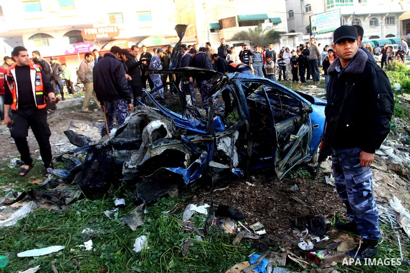 Palestinain policemen inspect the remains of a vehicle after it exploded in Gaza City March 9, 2012. Israel killed the leader of a Palestinian militant faction on Friday in a targeted attack on the car in the Gaza Strip,...