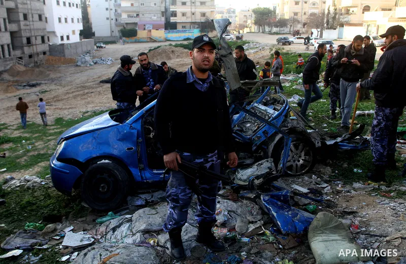 Palestinain policemen inspect the remains of a vehicle after it exploded in Gaza City March 9, 2012. Israel killed the leader of a Palestinian militant faction on Friday in a targeted attack on the car in the Gaza Strip,...