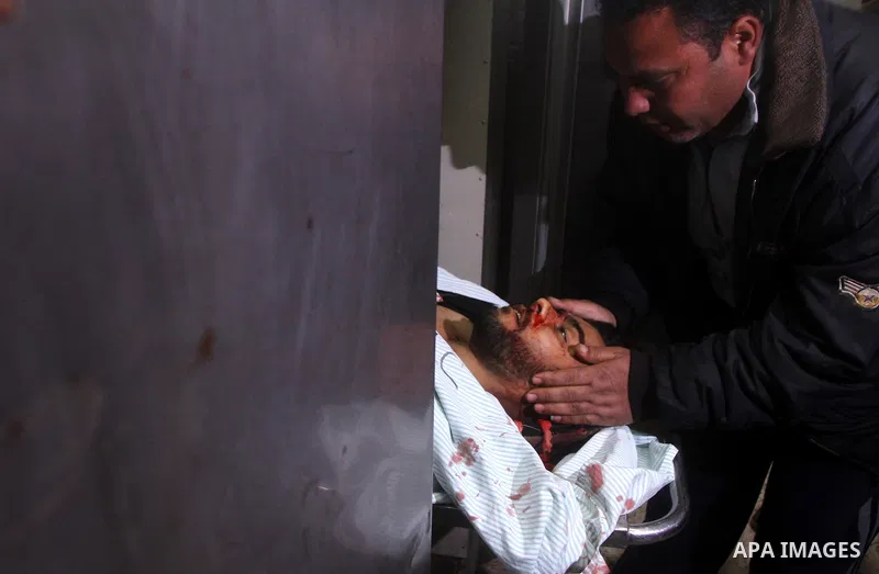 Palestinians mourn in a hospital over the body of one of two militants of the Al Quds Brigades, the military arm of Islamic Jihad, after they were killed in a second Israeli air strike in Gaza City on March 9, 2012, brin...