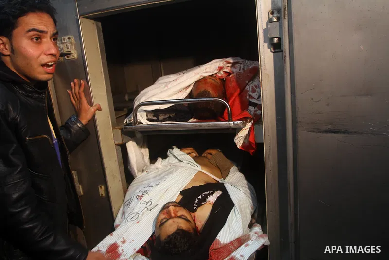 Palestinians mourn in a hospital over the body of one of two militants of the Al Quds Brigades, the military arm of Islamic Jihad, after they were killed in a second Israeli air strike in Gaza City on March 9, 2012, brin...