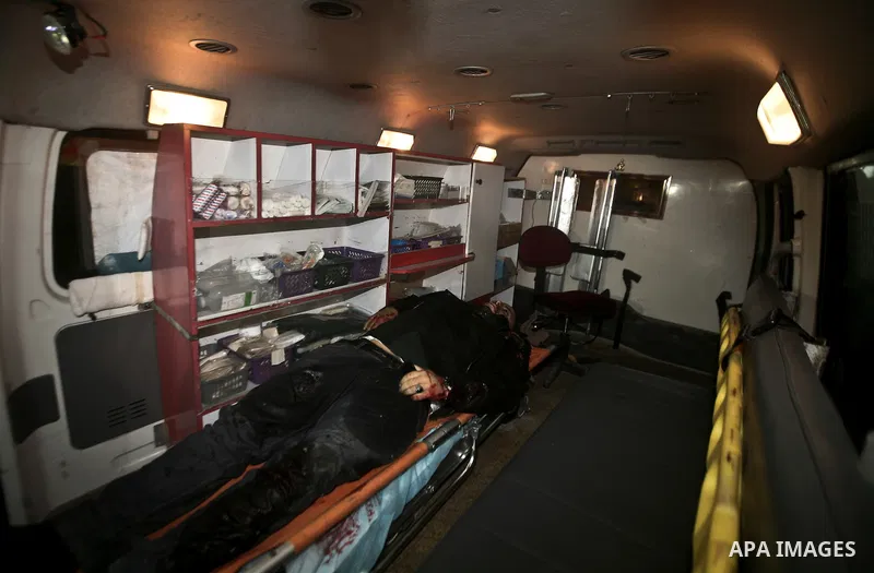 Palestinians mourn in a hospital over the body of one of two militants of the Al Quds Brigades, the military arm of Islamic Jihad, after they were killed in a second Israeli air strike in Gaza City on March 9, 2012, brin...