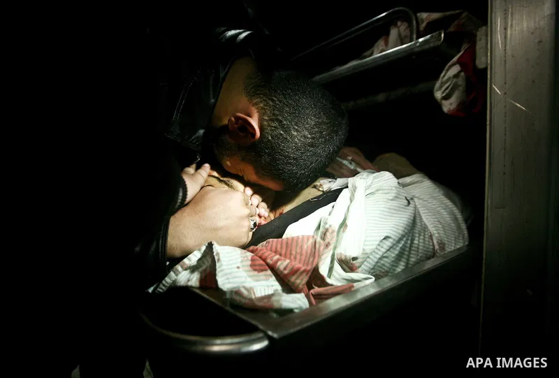 Palestinian mourn over the body islamic Jehad militant Hazem Kerekeaa in the al-Shifa hospital morgue on March 9, 2012, bringing the number of Palestinians killed in a day of cross-boarder fighting to four after a second...