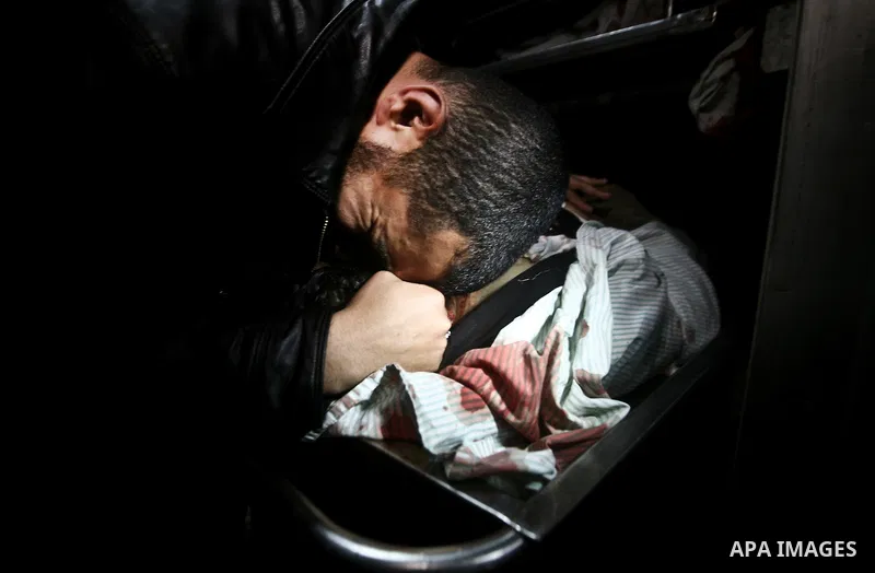 Palestinian mourn over the body islamic Jehad militant Hazem Kerekeaa in the al-Shifa hospital morgue on March 9, 2012, bringing the number of Palestinians killed in a day of cross-boarder fighting to four after a second...