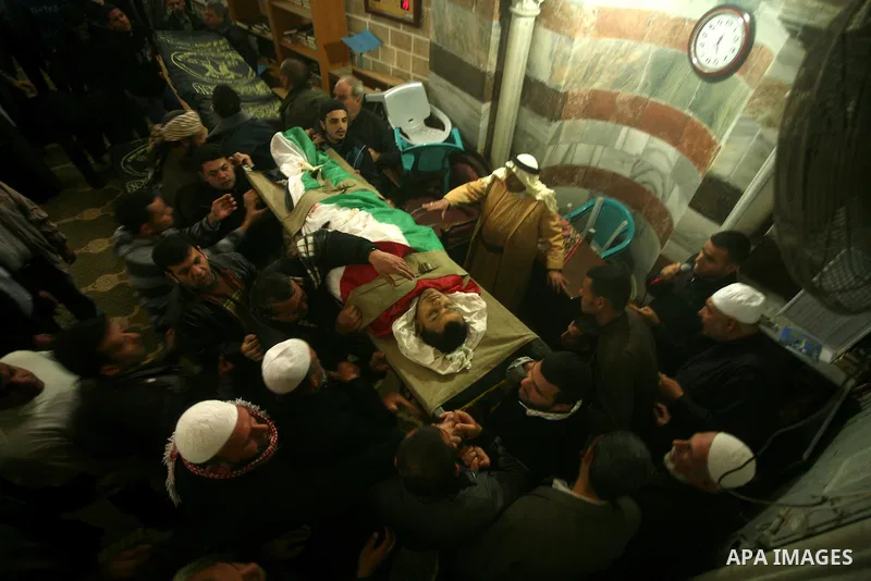 Palestinians carry the bodies of Islamic Jihad militants during their funeral in Gaza March 10, 2012. Israel killed two more Gaza militants on Saturday, raising the death toll in two days of violence to 12 and dozens of...
