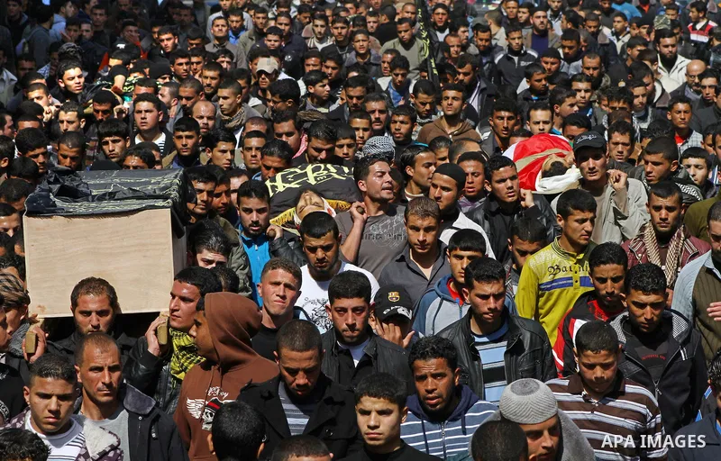 Palestinian mourners carry the bodies of seven Islamic Jihad militants (not all seen in picture), who were killed in Israeli air strikes, during their funeral in Gaza City on March 10, 2012. Twelve Palestinian fighters w...