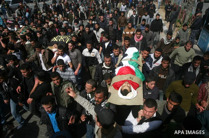Palestinian mourners carry the bodies of seven Islamic Jihad militants (not all seen in picture), who were killed in Israeli air strikes, during their funeral in Gaza City on March 10, 2012. Twelve Palestinian fighters w...
