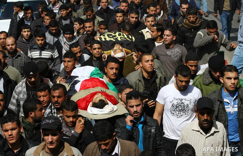 Palestinian mourners carry the bodies of seven Islamic Jihad militants (not all seen in picture), who were killed in Israeli air strikes, during their funeral in Gaza City on March 10, 2012. Twelve Palestinian fighters w...