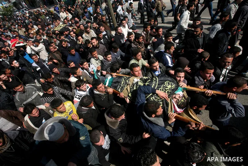Palestinian mourners carry the bodies of seven Islamic Jihad militants (not all seen in picture), who were killed in Israeli air strikes, during their funeral in Gaza City on March 10, 2012. Twelve Palestinian fighters w...