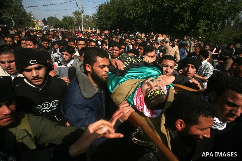 Palestinian mourners carry the bodies of seven Islamic Jihad militants (not all seen in picture), who were killed in Israeli air strikes, during their funeral in Gaza City on March 10, 2012. Twelve Palestinian fighters w...