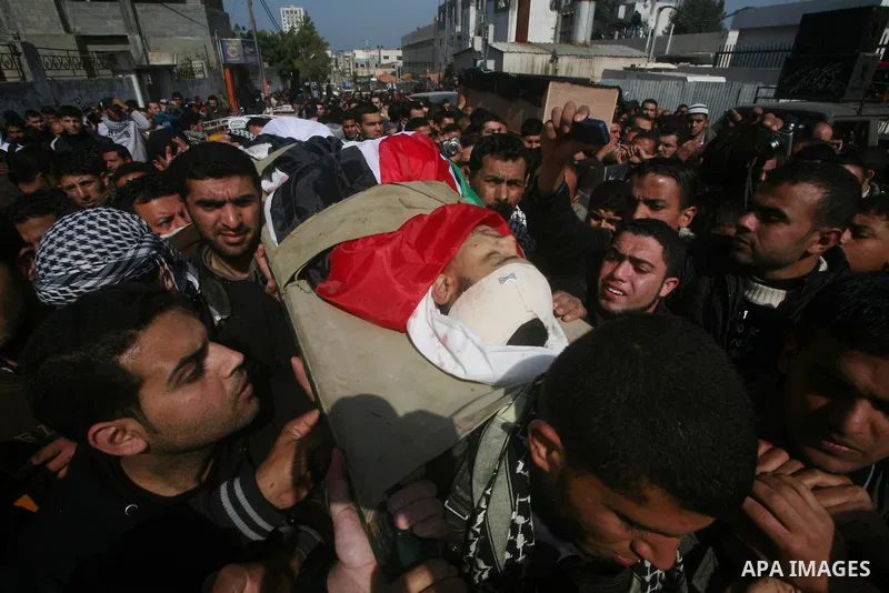 Palestinian mourners carry the bodies of seven Islamic Jihad militants (not all seen in picture), who were killed in Israeli air strikes, during their funeral in Gaza City on March 10, 2012. Twelve Palestinian fighters w...