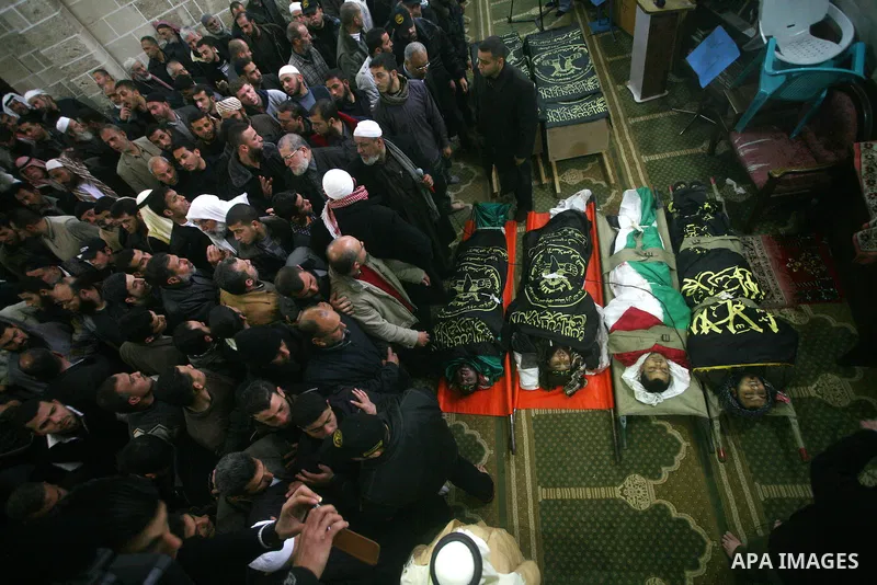 Palestinians pray near the bodies of Islamic Jihad militants during their funeral in Gaza March 10, 2012. Israel killed two more Gaza militants on Saturday, raising the death toll in two days of violence to 12 and dozens...
