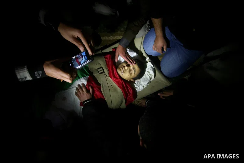Palestinian relatives of Islamic Jihad militant Ahmed Hajaj mourns during his funeral in Gaza March 10, 2012. Israel killed two more Gaza militants on Saturday, raising the death toll in two days of violence to 12 and do...