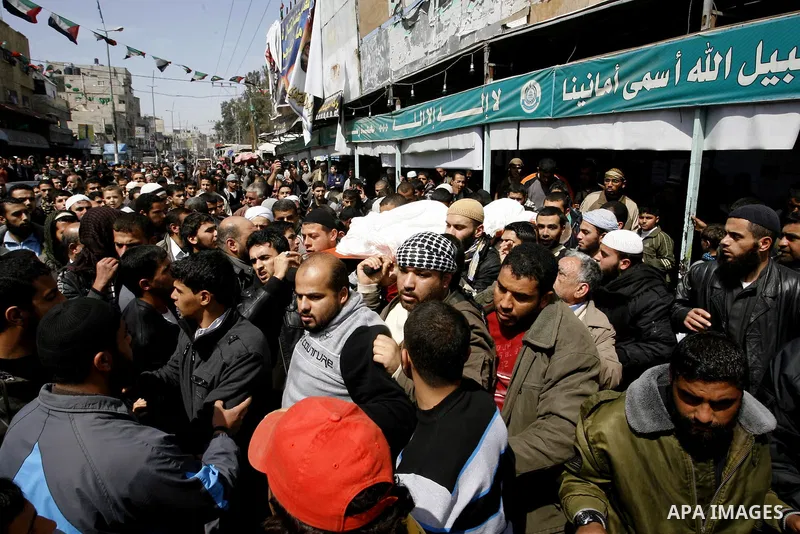 Palestinians carry the body of the Popular Resistance Committees leader Zuheir al-Qessi during his funeral in Rafah in the southern Gaza Strip March 10, 2012. Israel killed four Gaza militants on Saturday as violence spa...
