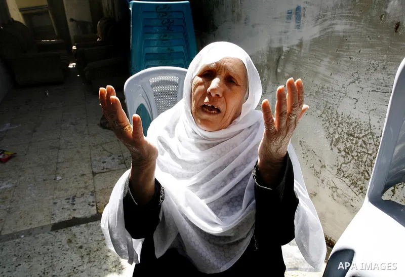 Palestinian relatives of the Secretary-General of the Popular Resistance Committees, Zuhair al-Qaisi mourn during his funeral, after he was killed in an Israeli air strike on a car traveling in Rafah. Fourteen Palestinia...