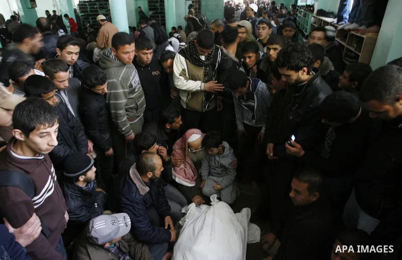 Palestinian relatives gather around the body of Popular Resistance Committees secretary-general Zuhir al-Qaisi's covered body at Al Awda Mosque, in Rafah. Fourteen Palestinian were killed and at least 20 people wounded i...