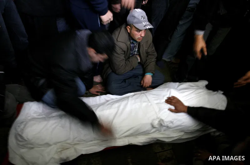 Palestinian relatives gather around the body of Popular Resistance Committees secretary-general Zuhir al-Qaisi's covered body at Al Awda Mosque, in Rafah. Fourteen Palestinian were killed and at least 20 people wounded i...