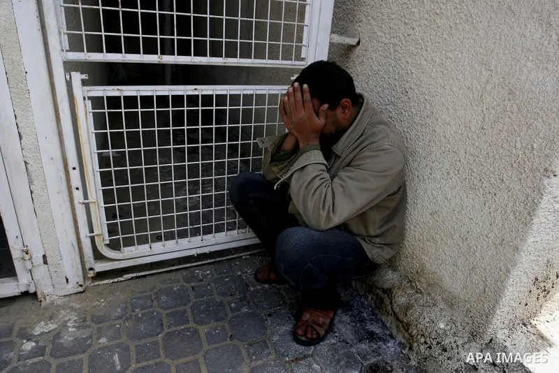 A Palestinian man react at a hospital following an Israeli air strike in Khan Younis in the southern Gaza Strip March 10, 2012. Israel killed four Gaza militants on Saturday as violence sparked by the death of a militant...