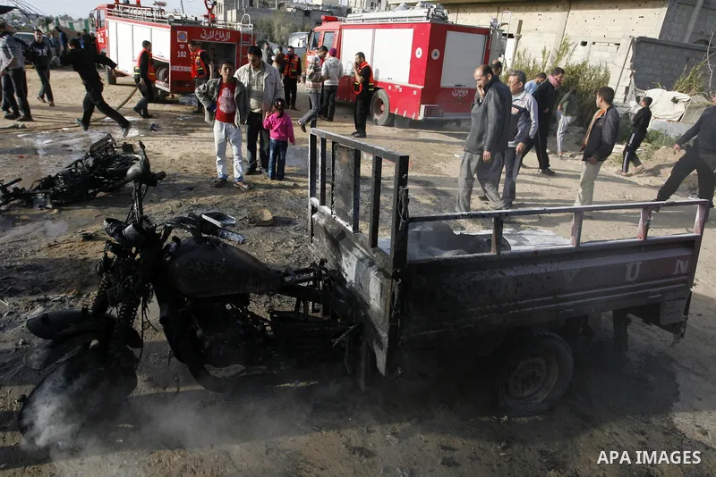 Palestinians inspect the damage of a motorcycle bombing executed by an Israeli airstrike in Rafah, southern Gaza Strip, Saturday, March 10, 2012. The airstrike killed Popular Resistance Committees militant Mahdi Abu Shaw...