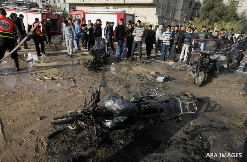 Palestinians inspect the damage of a motorcycle bombing executed by an Israeli airstrike in Rafah, southern Gaza Strip, Saturday, March 10, 2012. The airstrike killed Popular Resistance Committees militant Mahdi Abu Shaw...