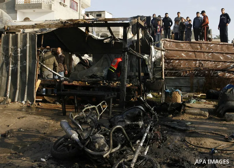 Palestinians inspect the damage of a motorcycle bombing executed by an Israeli airstrike in Rafah, southern Gaza Strip, Saturday, March 10, 2012. The airstrike killed Popular Resistance Committees militant Mahdi Abu Shaw...