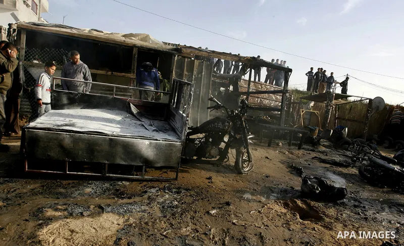 Palestinians inspect the damage of a motorcycle bombing executed by an Israeli airstrike in Rafah, southern Gaza Strip, Saturday, March 10, 2012. The airstrike killed Popular Resistance Committees militant Mahdi Abu Shaw...