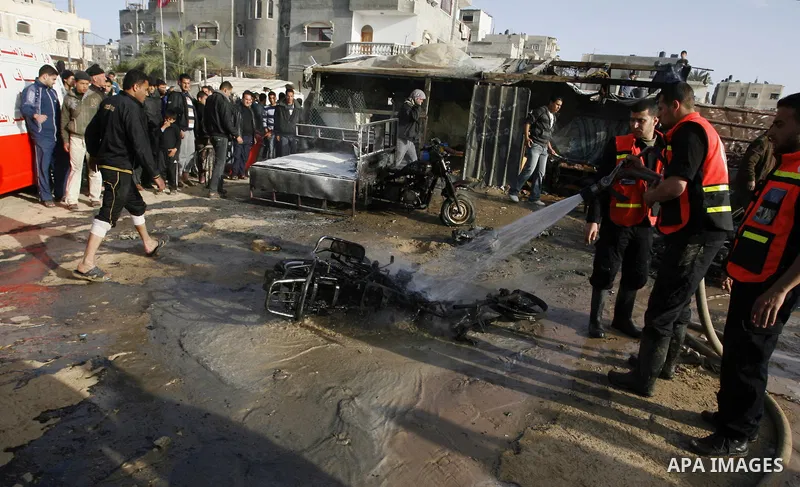 Palestinian Firefighters tries to extinguish a fire after an Israeli airstrike in Rafah, southern Gaza Strip, Saturday, March 10, 2012. The airstrike killed Popular Resistance Committees militant Mahdi Abu Shawesh. Despi...