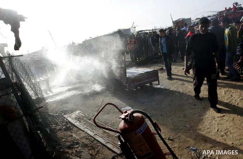 Palestinians inspect the damage of a motorcycle bombing executed by an Israeli airstrike in Rafah, southern Gaza Strip, Saturday, March 10, 2012. The airstrike killed Popular Resistance Committees militant Mahdi Abu Shaw...