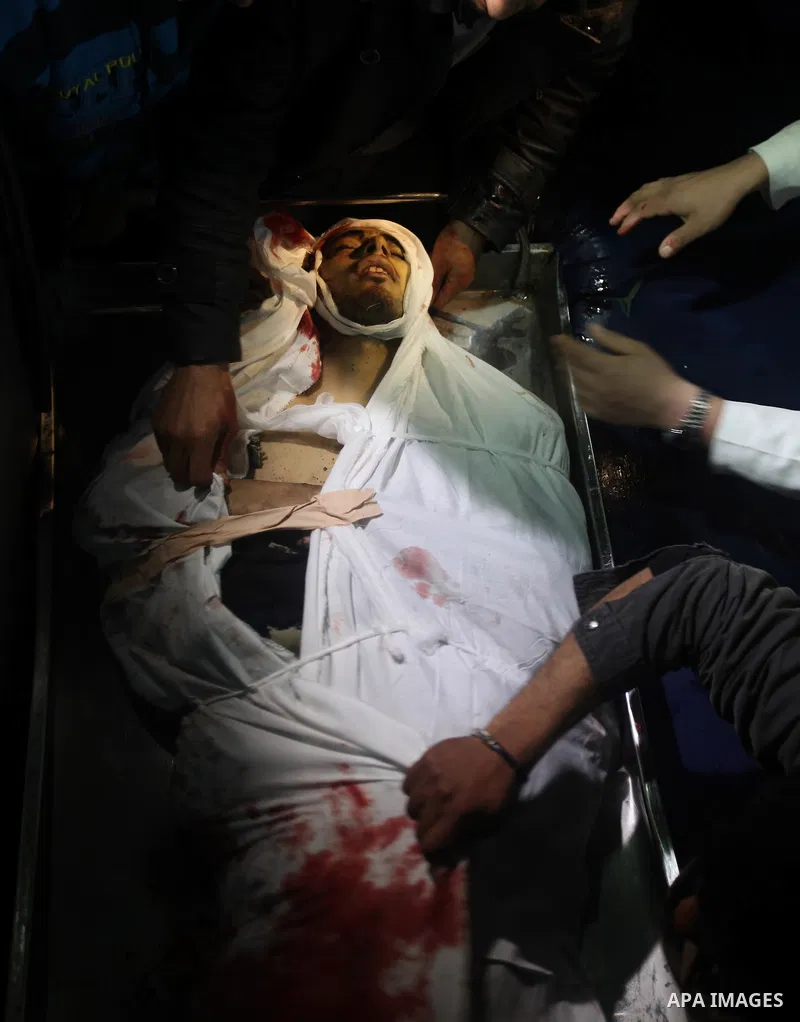Relatives of Ahmed salem, 22-year-old, look at his body in the morgue of Al-Shifa hospital in Gaza City, on March 11, 2012, following a fresh Israeli air raid, bringing the death toll from strikes since March 10 to 17 an...